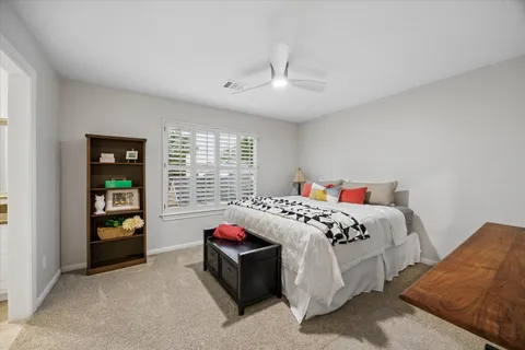 a bedroom with bed and a window