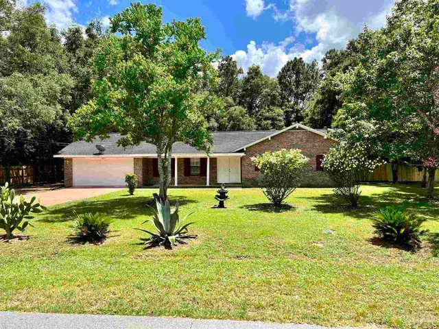 a swimming pool with outdoor seating and yard