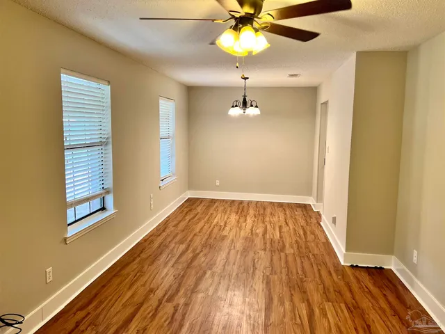 a view of empty room with fireplace and fan