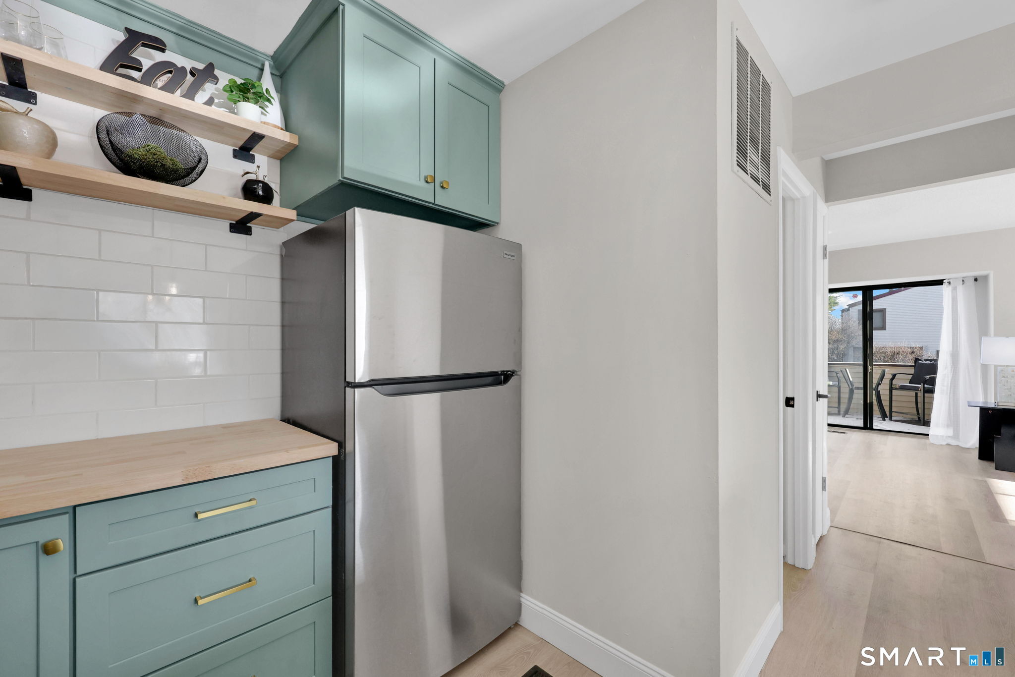 273 Cottonwood Road, Unit 273 Newington, CT 06111 - Photo 11 of 38 a kitchen with a refrigerator and cabinets