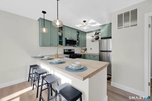 a kitchen with a dining table and chairs