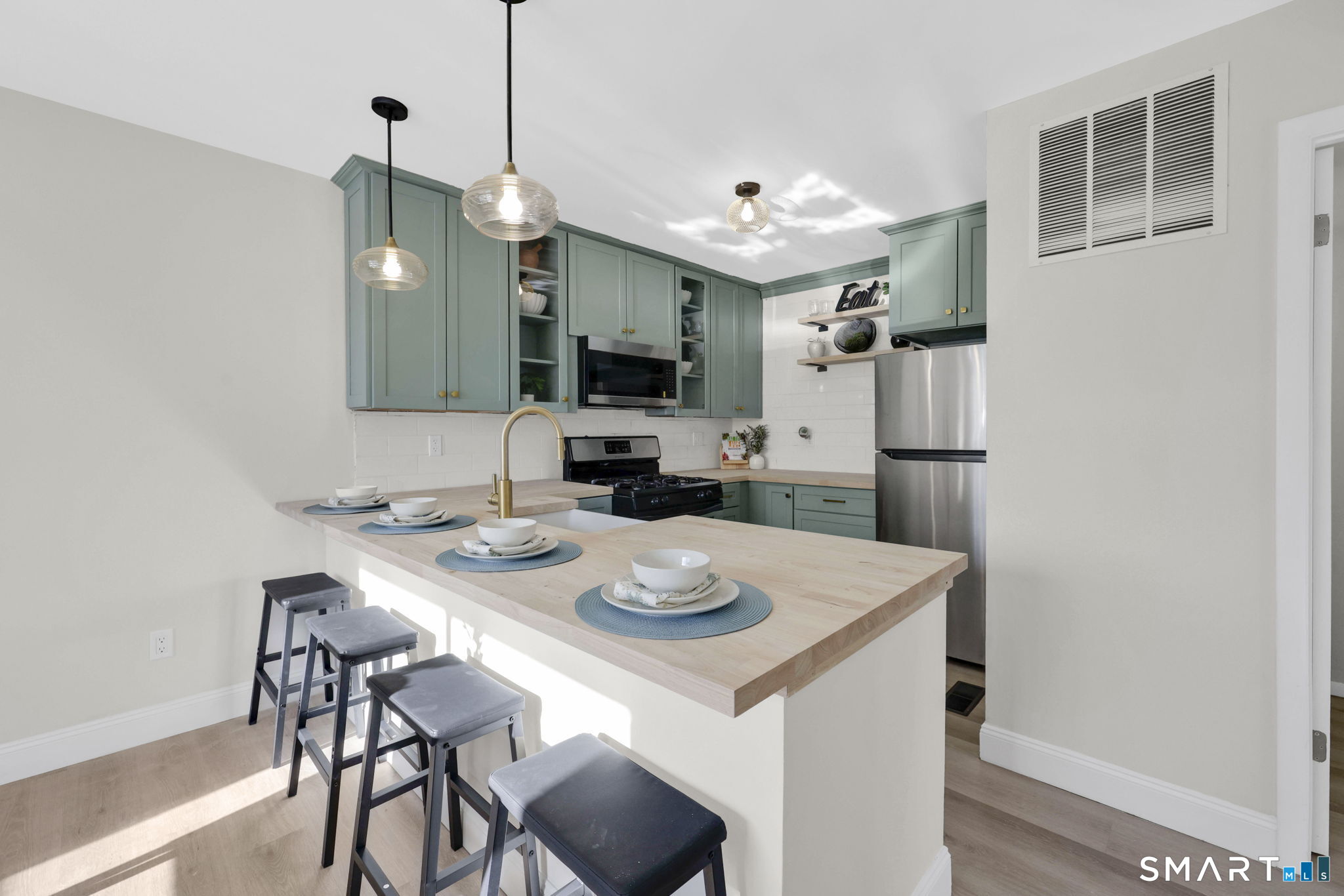 273 Cottonwood Road, Unit 273 Newington, CT 06111 - Photo 12 of 38 a kitchen with a dining table and chairs