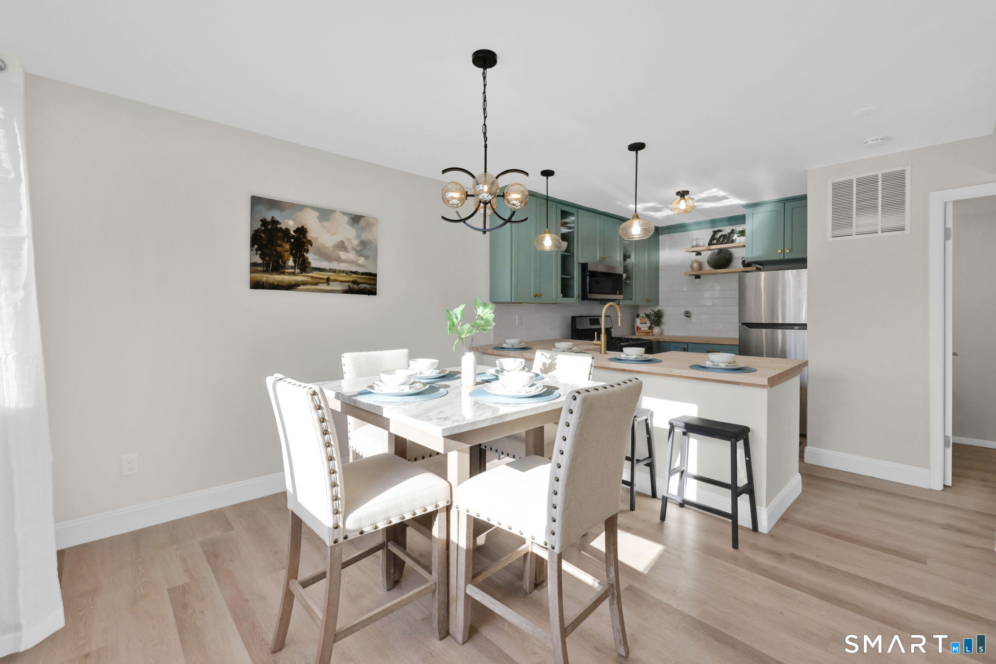 273 Cottonwood Road, Unit 273 Newington, CT 06111 - Photo 13 of 38 a view of a dining room with furniture and wooden floor
