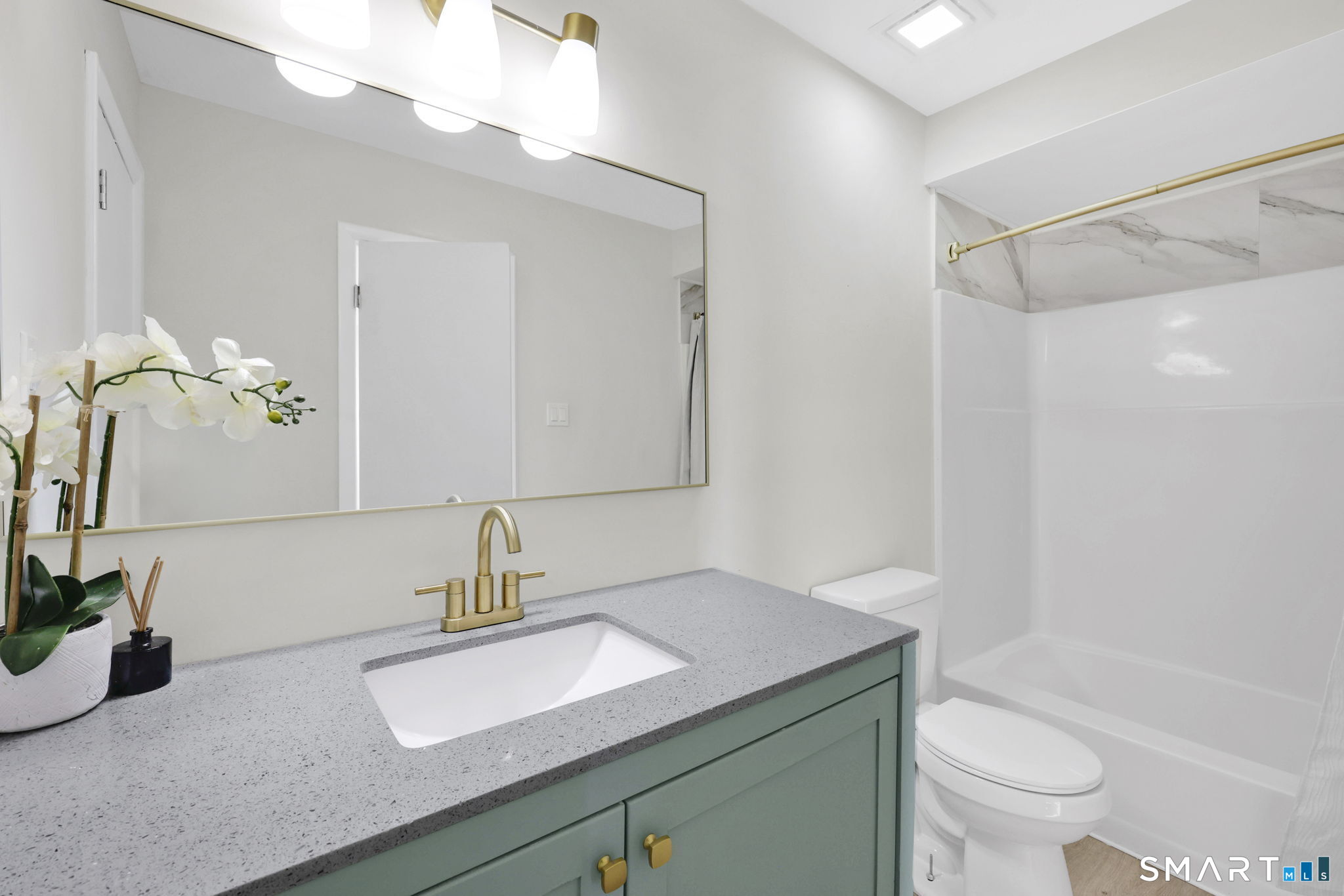 273 Cottonwood Road, Unit 273 Newington, CT 06111 - Photo 19 of 38 a bathroom with a sink a toilet and a mirror