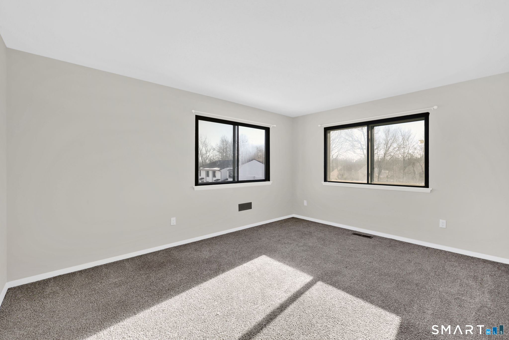 273 Cottonwood Road, Unit 273 Newington, CT 06111 - Photo 21 of 38 an empty room with windows & cabinet