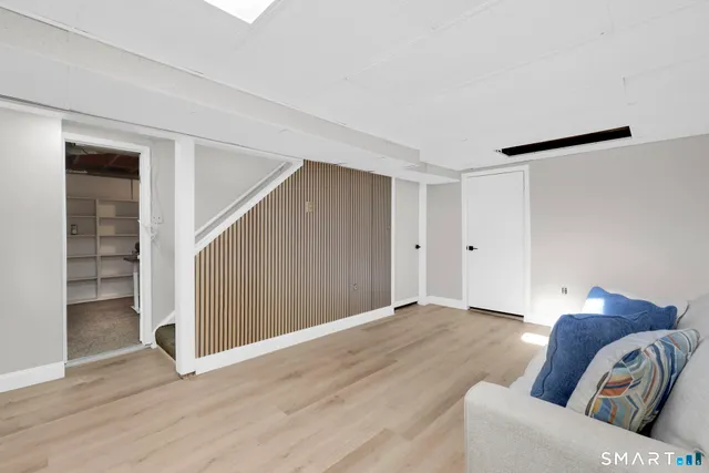 a living room with furniture and a ceiling fan