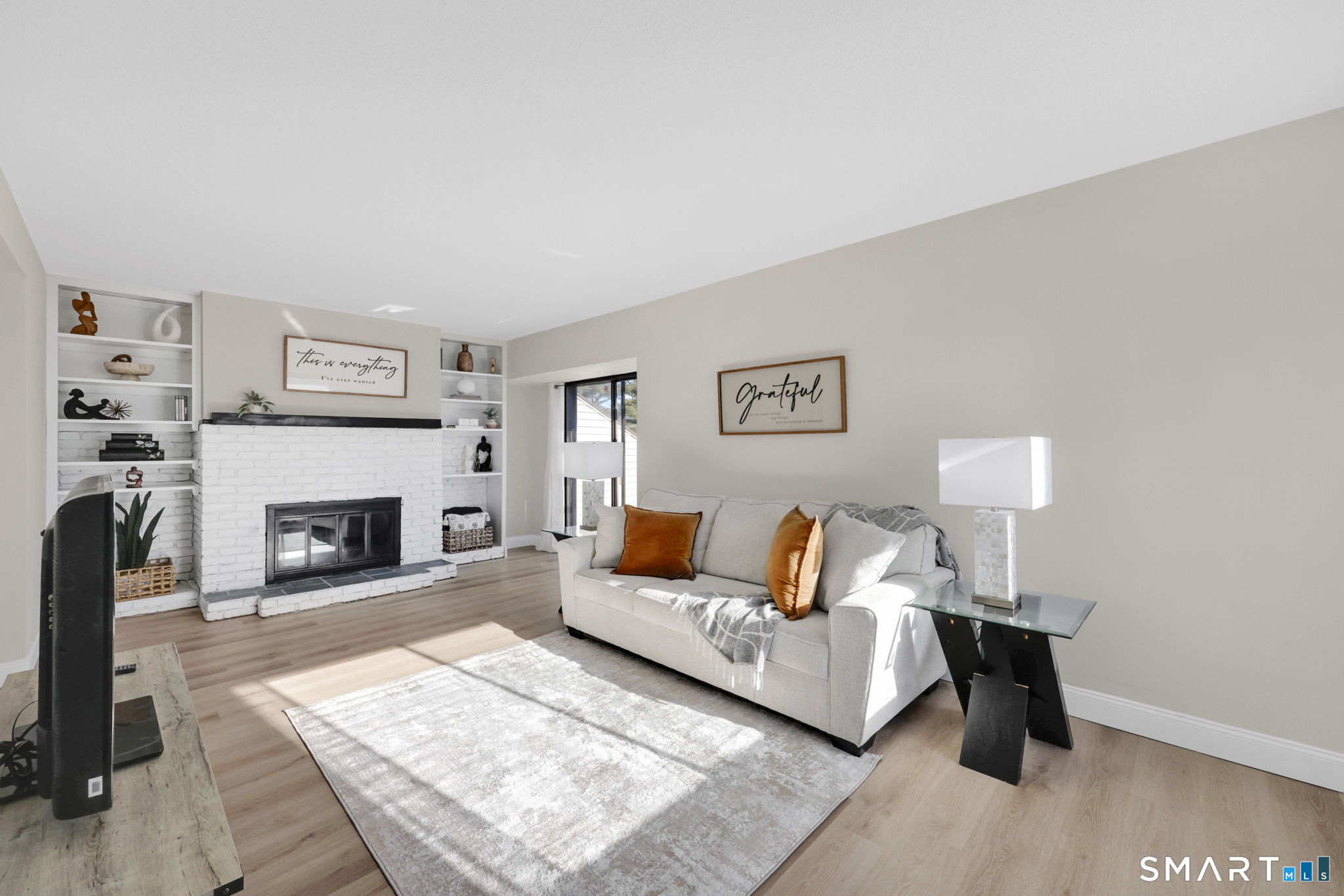 273 Cottonwood Road, Unit 273 Newington, CT 06111 - Photo 4 of 38 a living room with furniture and a fireplace