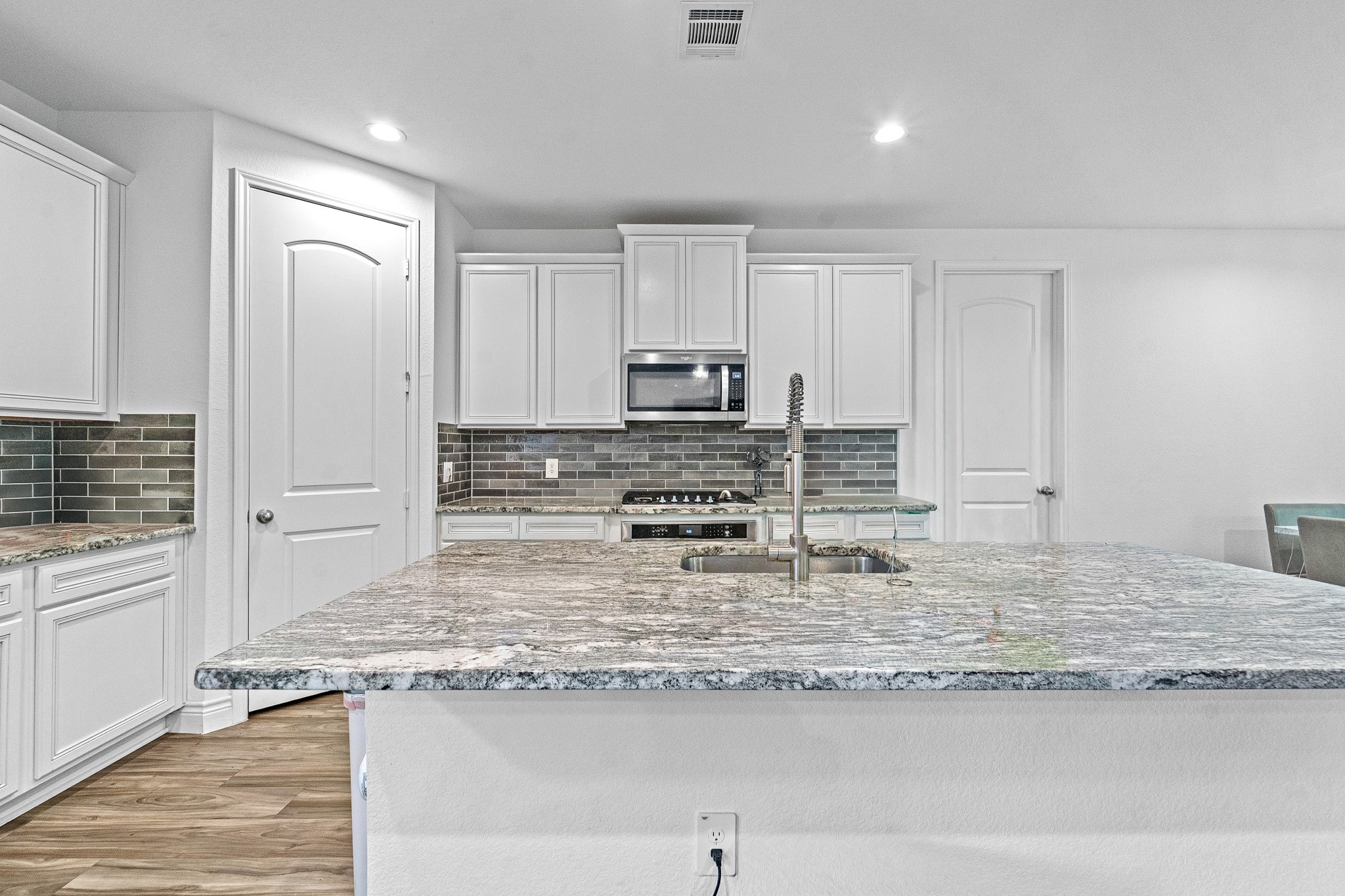 15814 Gibson Grass Court Spring, TX 77379 - Photo 6 of 26 a kitchen with granite countertop kitchen island a stove a sink and a refrigerator