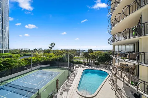 a view of a swimming pool with outdoor seating and plants