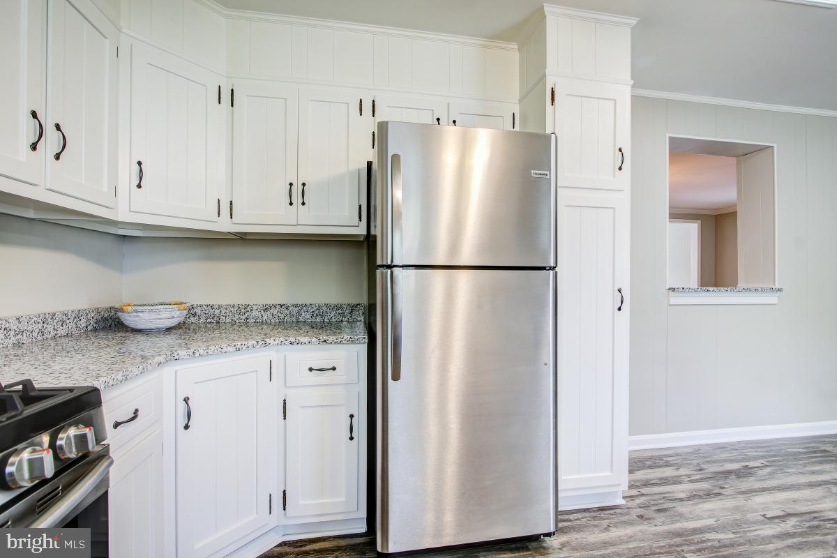 11803 Rocking Horse Road Rockville, MD 20852 - Photo 15 of 28 a white refrigerator freezer sitting inside of a kitchen