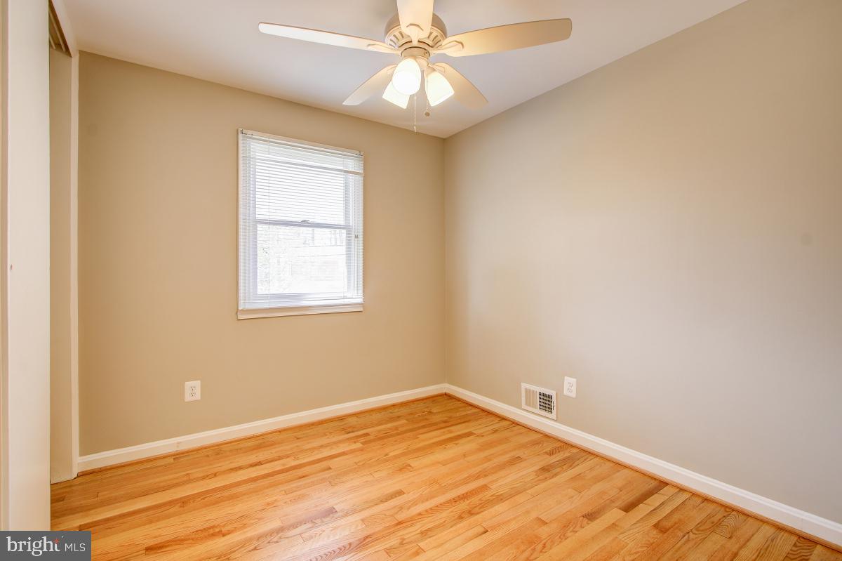 11803 Rocking Horse Road Rockville, MD 20852 - Photo 17 of 28 an empty room with a window and wooden floor