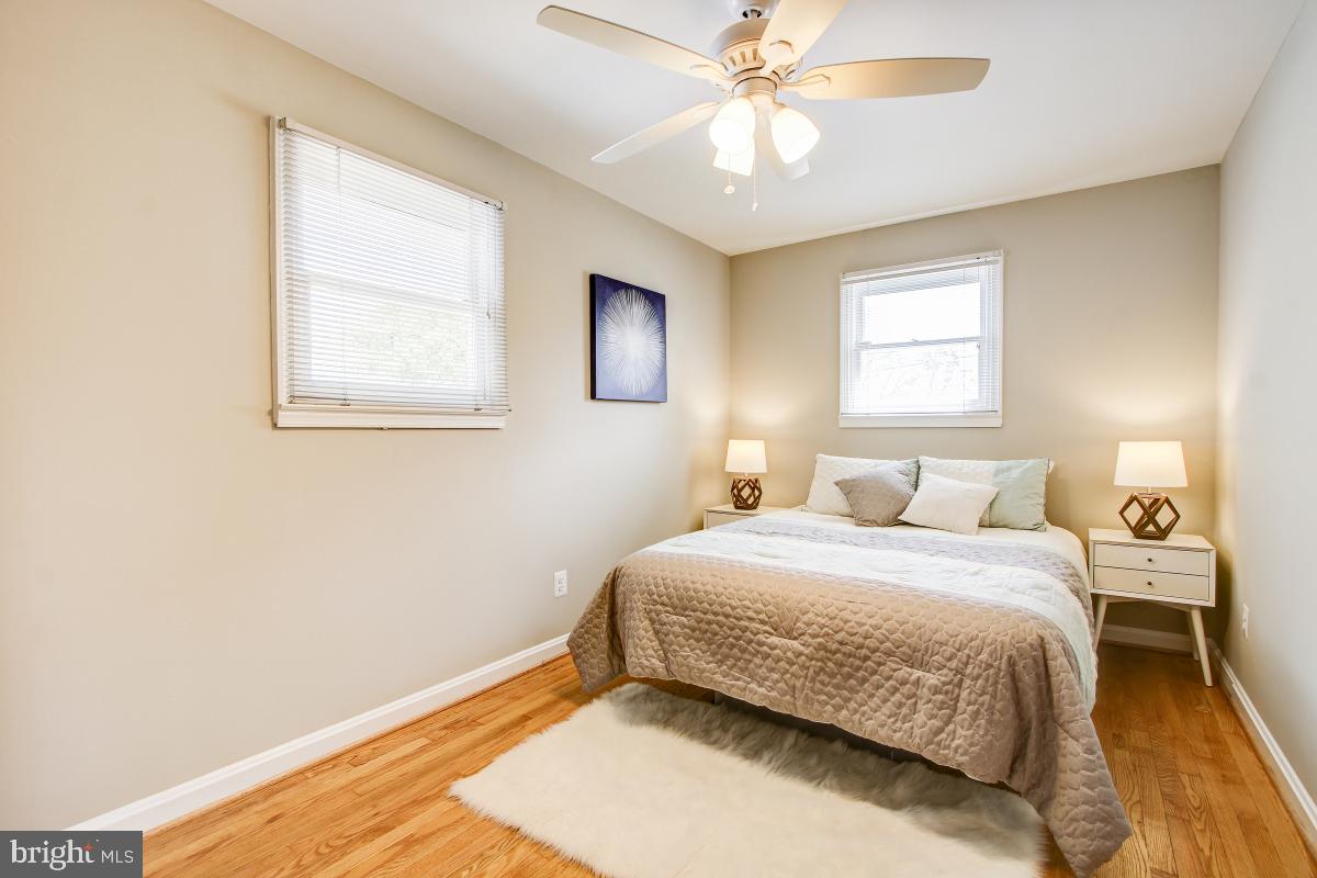 11803 Rocking Horse Road Rockville, MD 20852 - Photo 19 of 28 a bedroom with a bed and a chandelier