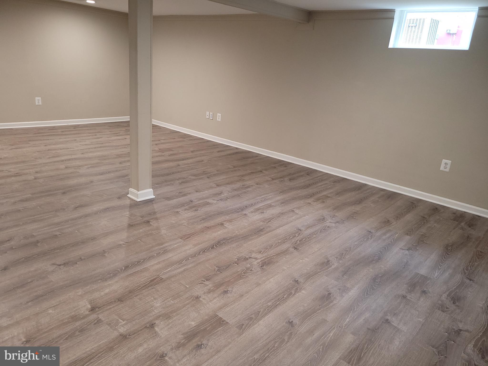 11803 Rocking Horse Road Rockville, MD 20852 - Photo 23 of 28 a view of an empty room with wooden floor and a window