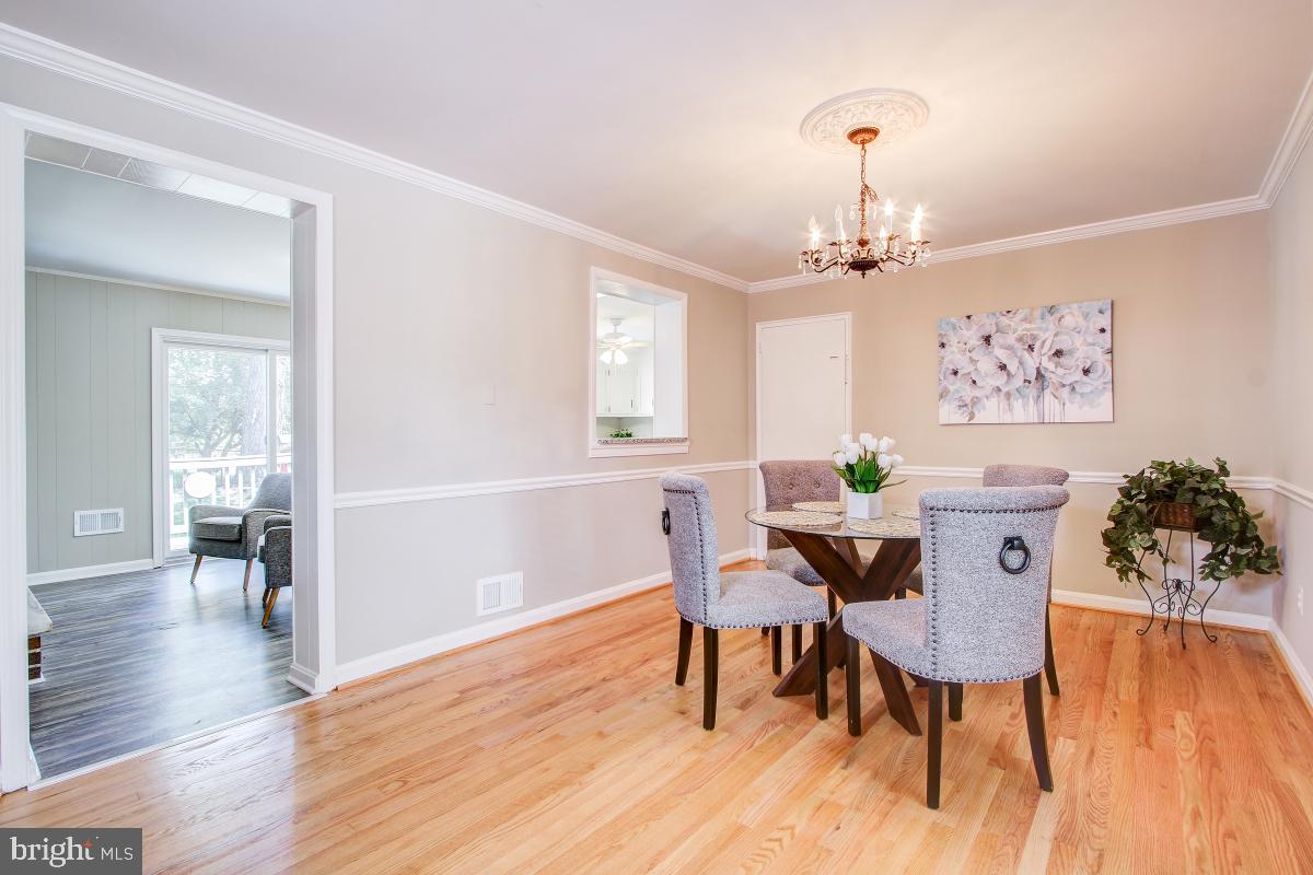 11803 Rocking Horse Road Rockville, MD 20852 - Photo 6 of 28 a view of a dining room with furniture and wooden floor
