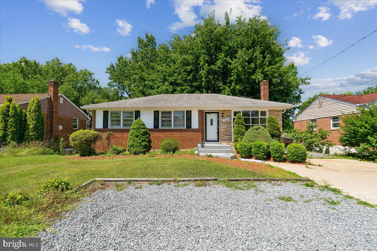 13012 Georgia Avenue Silver Spring, MD 20906 - Photo 2 of 31 Charming brick home with lush greenery.