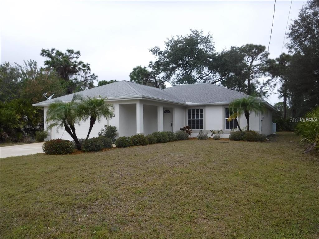 234 Wayne Road Rotonda West, FL 33947 - Photo 1 of 1 a house that has a tree in front of it