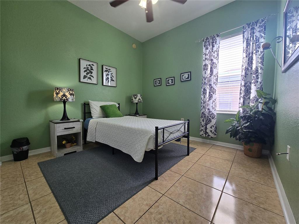 219 Cloverdale Road Winter Haven, FL 33884 - Photo 20 of 29 a bedroom with a bed and a chandelier