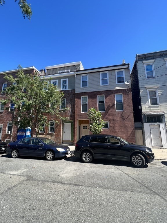 306 Sumner Street Boston, MA 02128 - Photo 2 of 7 a couple of cars parked in front of a building