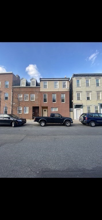 306 Sumner Street Boston, MA 02128 - Photo 4 of 7 a car parked in front of a building
