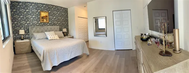 a spacious bedroom with a bed and a large window