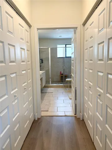 a bathroom with a sink a mirror and shower