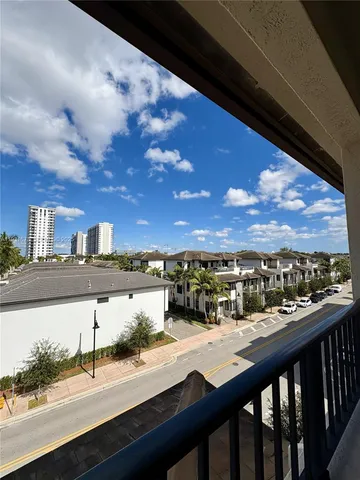 a living room with furniture potted plant and a chandelier