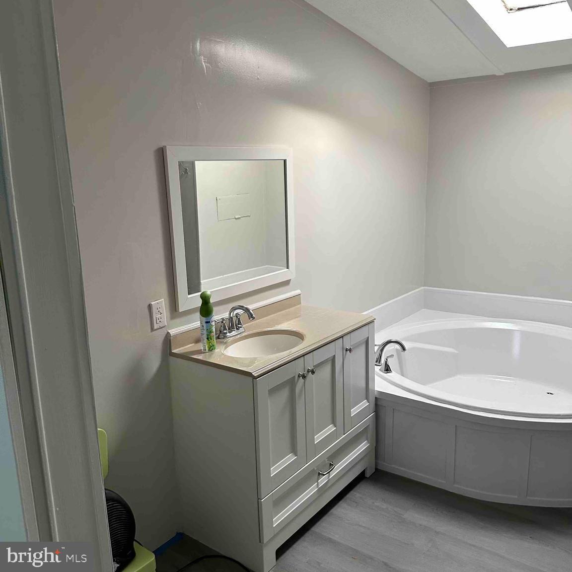 8353 Ashwood Road, Unit 8353 Jessup, MD 20794 - Photo 3 of 11 a bathroom with a tub sink and mirror