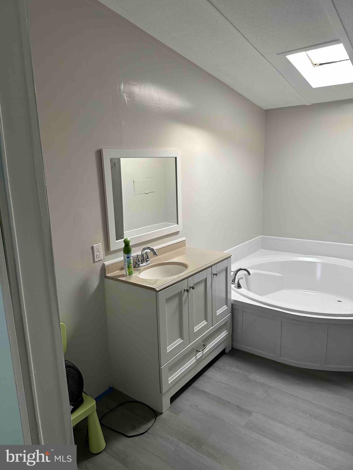 8353 Ashwood Road, Unit 8353 Jessup, MD 20794 - Photo 9 of 11 a bathroom with a granite countertop sink and a mirror