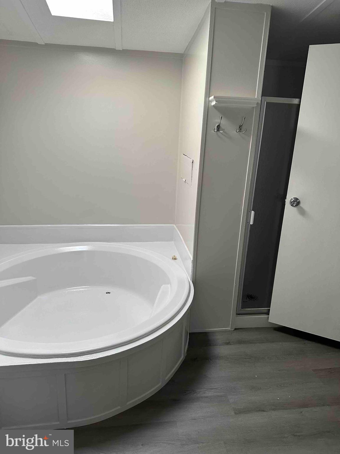 8353 Ashwood Road, Unit 8353 Jessup, MD 20794 - Photo 10 of 11 a white bath tub sitting in a bathroom