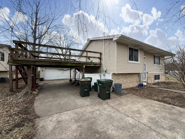 a view of two chairs with a table in the patio