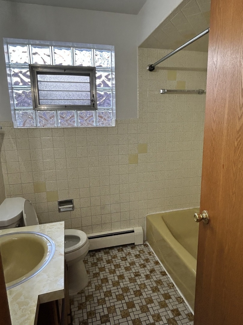 5350 North Central Avenue, Unit 1 Chicago, IL 60630 - Photo 11 of 24 a bathroom with a sink a toilet and shower