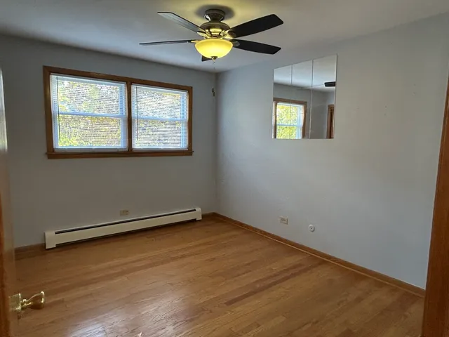 a bathroom with a granite countertop sink a toilet and a mirror