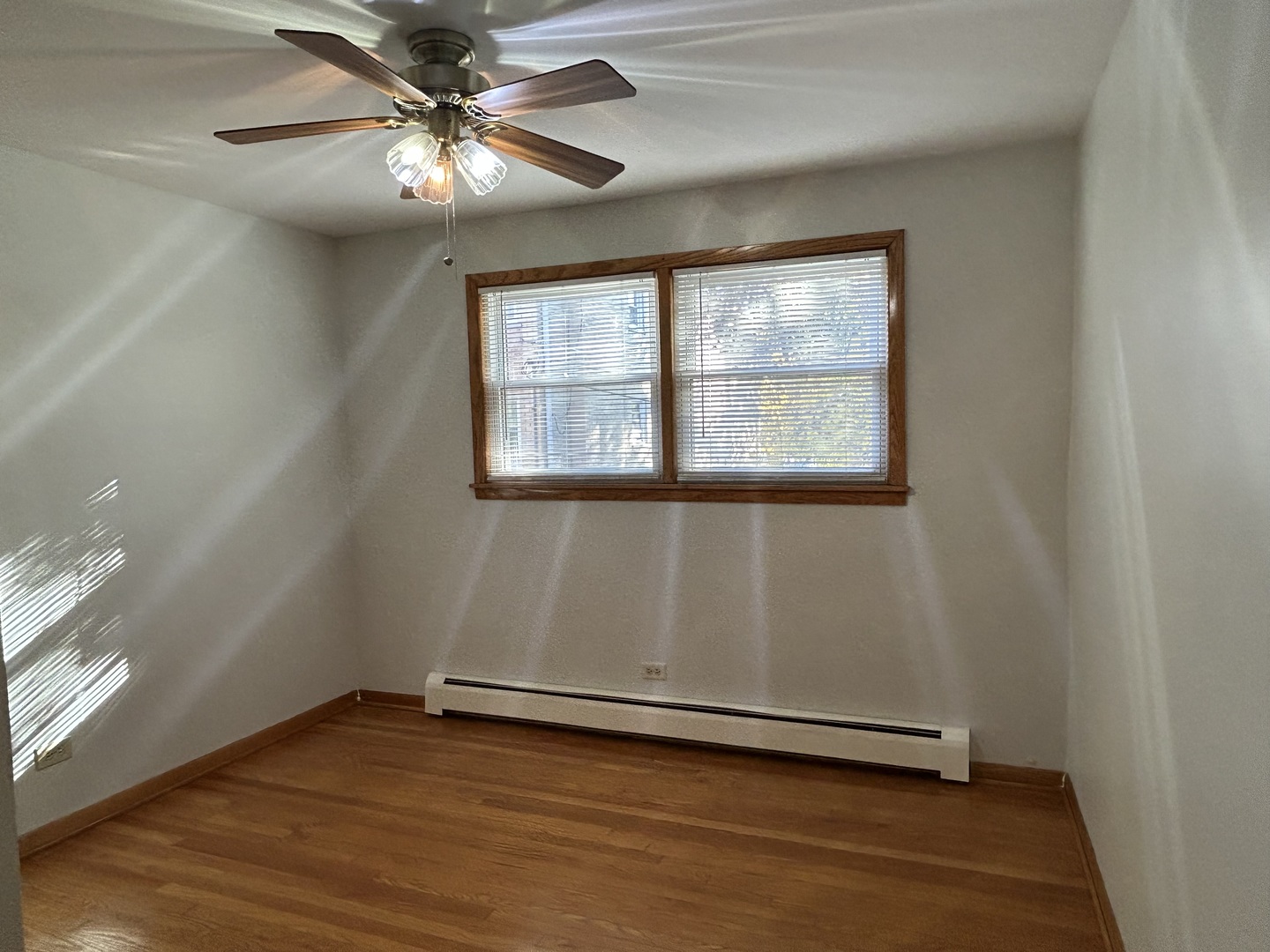 5350 North Central Avenue, Unit 1 Chicago, IL 60630 - Photo 14 of 24 an empty room with wooden floor and windows