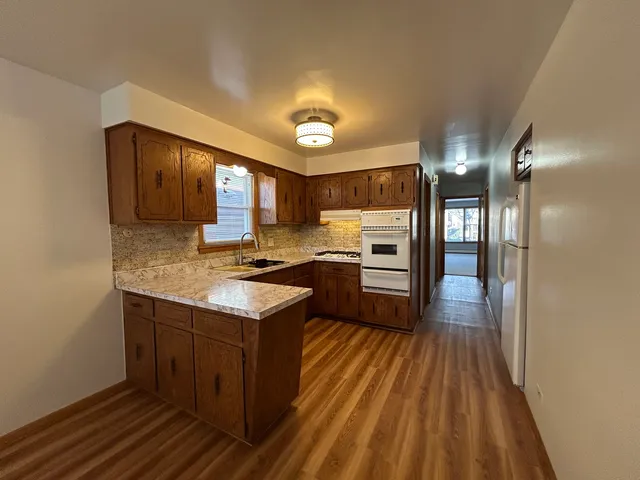 a kitchen with a sink stove and cabinets