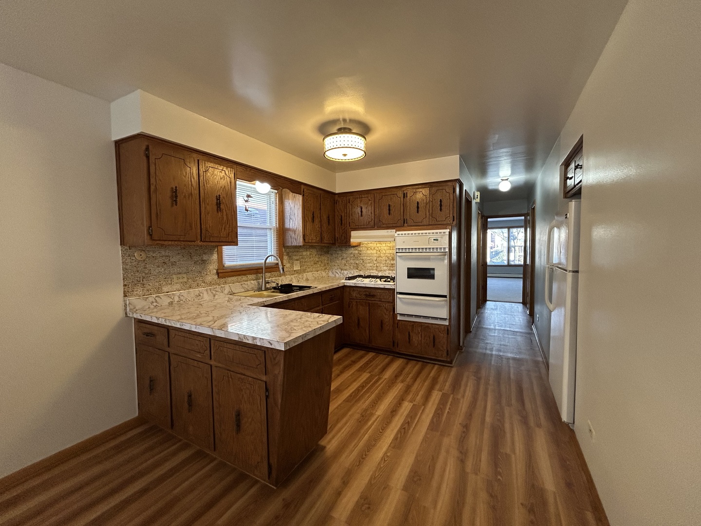 5350 North Central Avenue, Unit 1 Chicago, IL 60630 - Photo 15 of 24 a kitchen with granite countertop a sink cabinets and stainless steel appliances