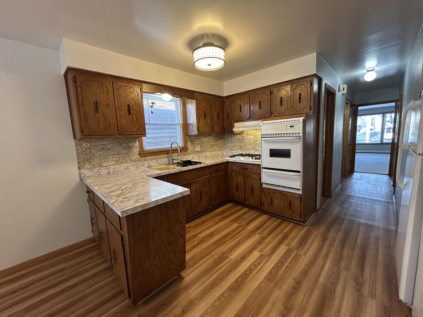 5350 North Central Avenue, Unit 1 Chicago, IL 60630 - Photo 17 of 24 a kitchen with stainless steel appliances granite countertop a sink stove and refrigerator