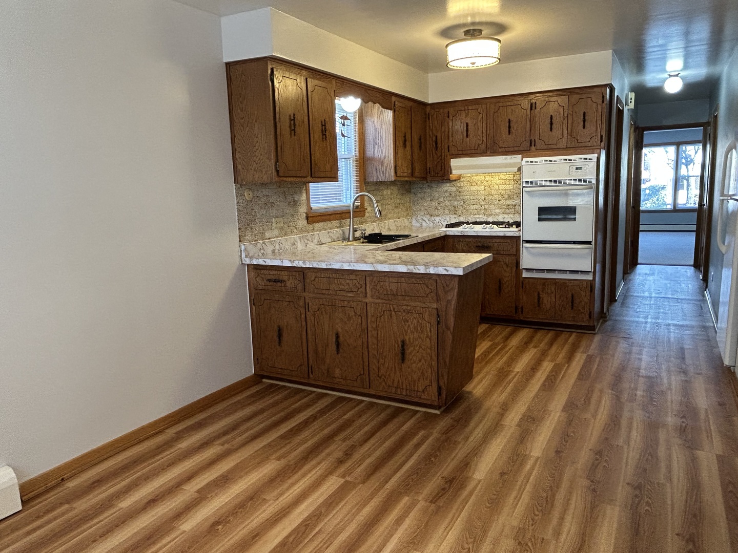 5350 North Central Avenue, Unit 1 Chicago, IL 60630 - Photo 18 of 24 a kitchen with stainless steel appliances granite countertop a stove a sink and a refrigerator
