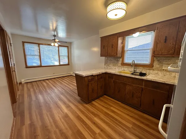 a kitchen with wooden floors and a sink