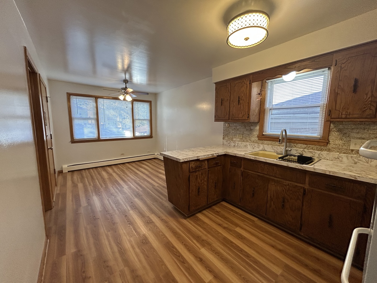 5350 North Central Avenue, Unit 1 Chicago, IL 60630 - Photo 23 of 24 a kitchen with wooden floors and a sink