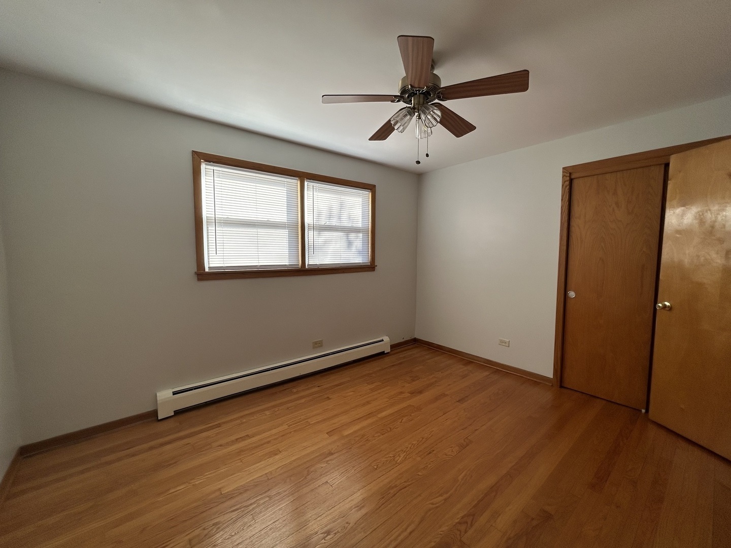 5350 North Central Avenue, Unit 1 Chicago, IL 60630 - Photo 9 of 24 a view of empty room with wooden floor and fan