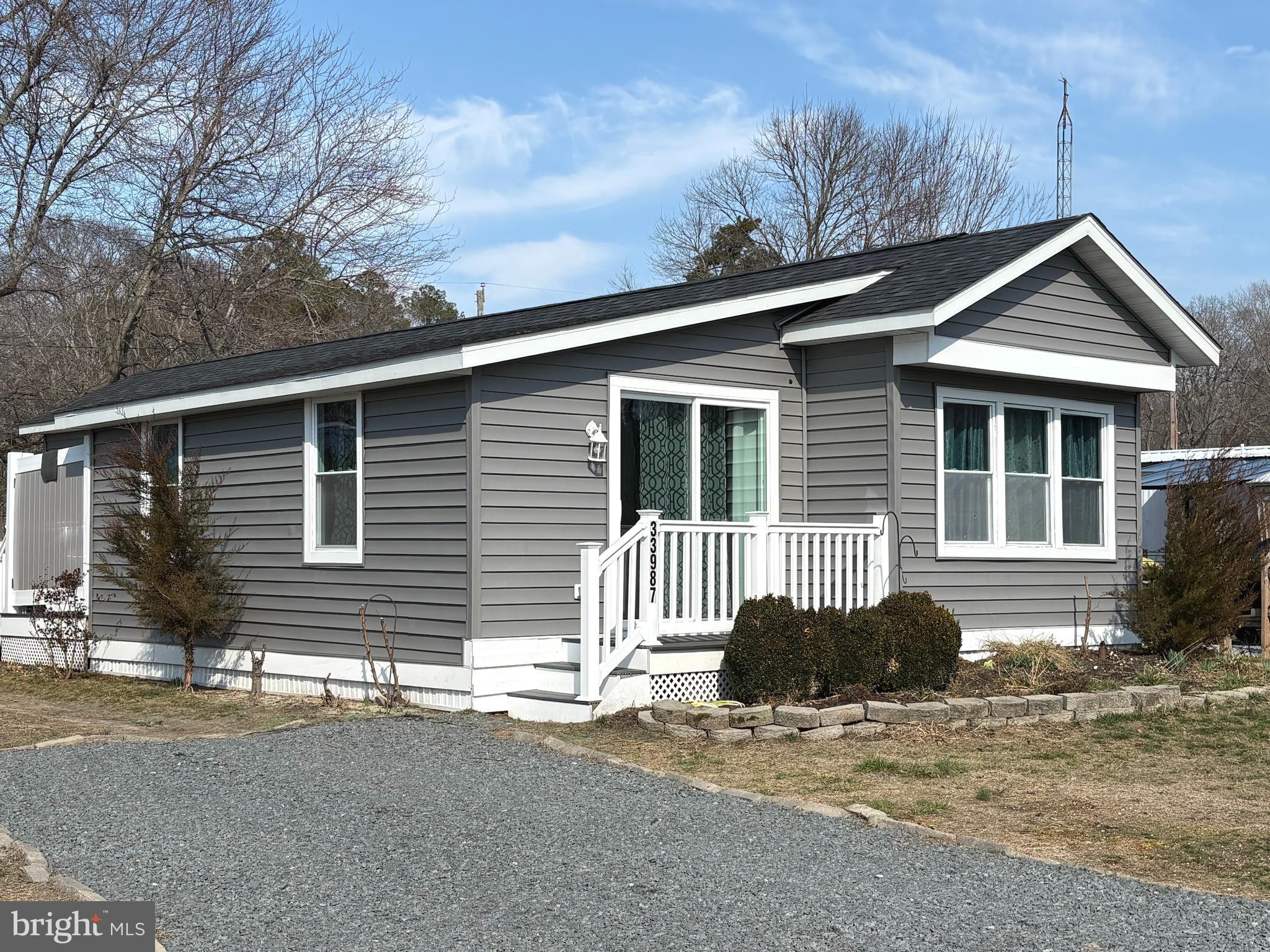 33987 Sunflower Road, Unit 3831 Lewes, DE 19958 - Photo 1 of 17 a front view of a house with a garage