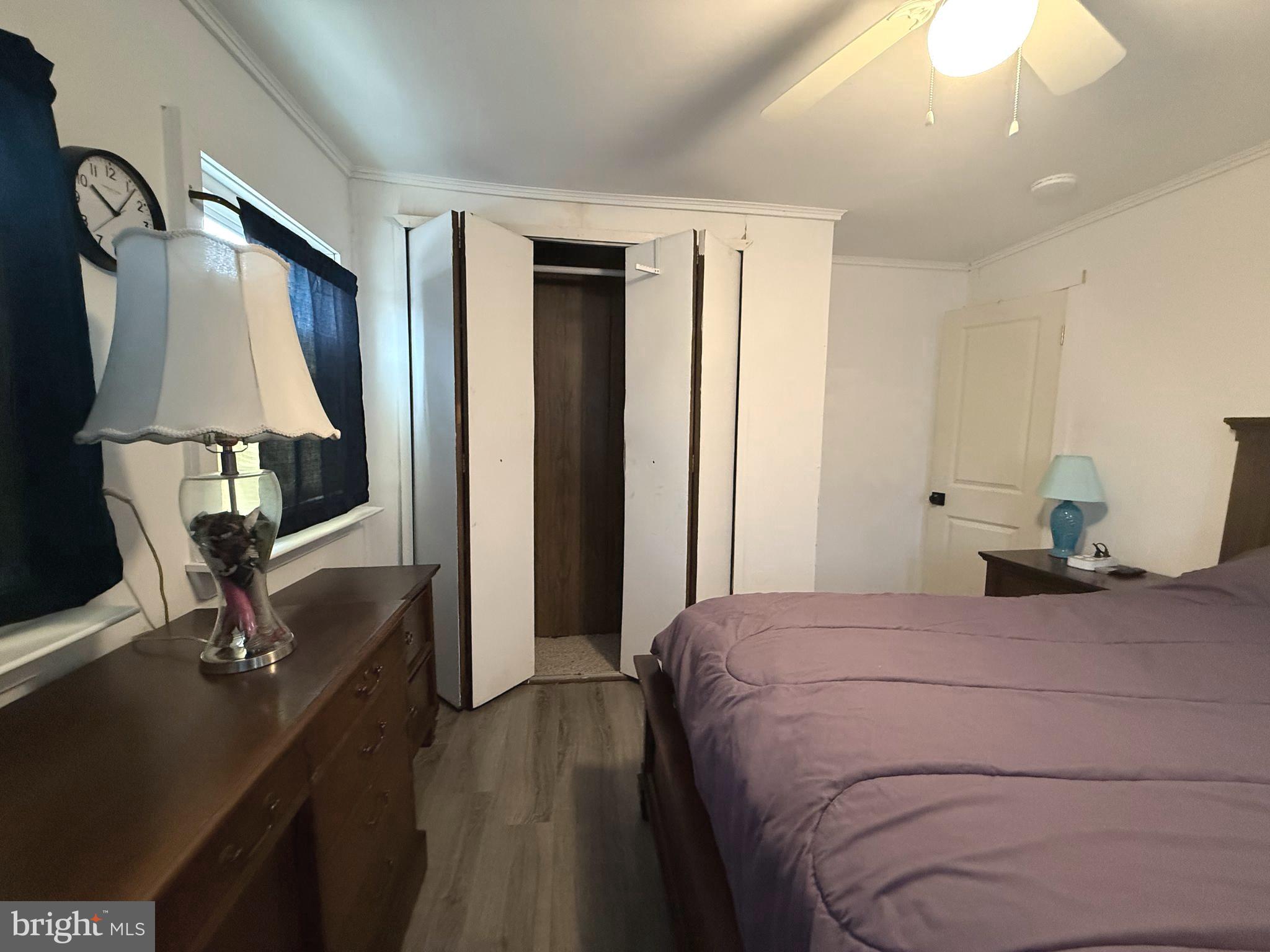 33987 Sunflower Road, Unit 3831 Lewes, DE 19958 - Photo 16 of 17 a bedroom with a bed and a mirror