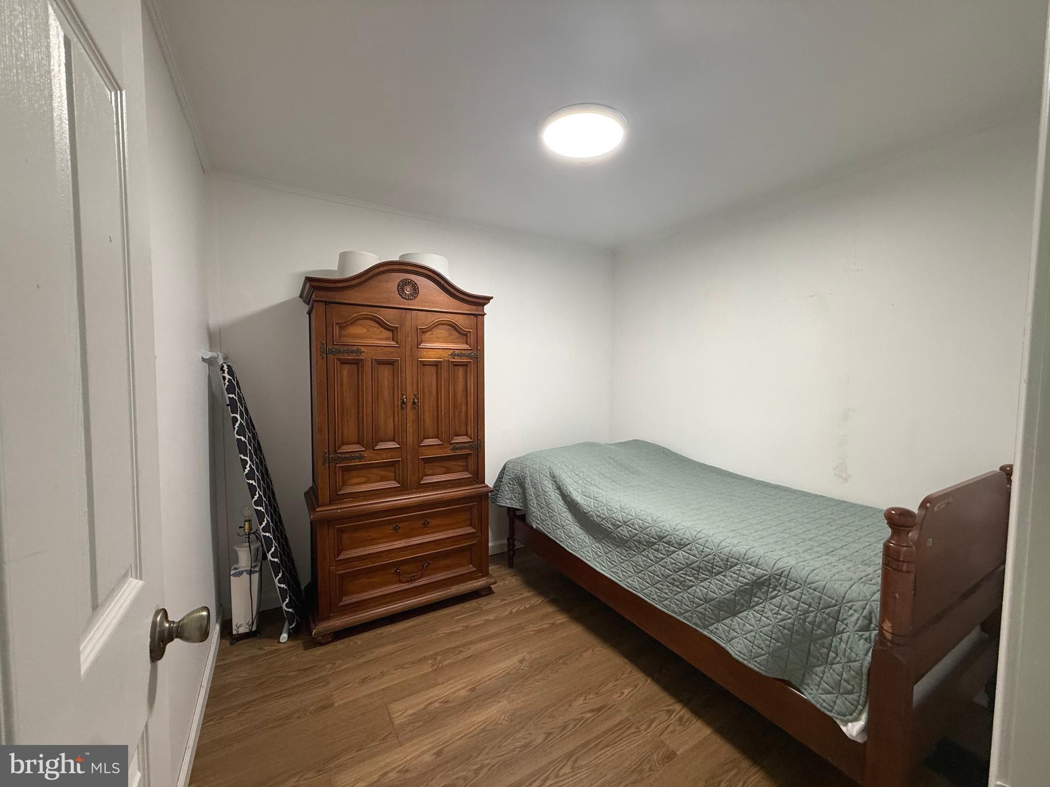 33987 Sunflower Road, Unit 3831 Lewes, DE 19958 - Photo 17 of 17 a view of bedroom with furniture and wooden floor