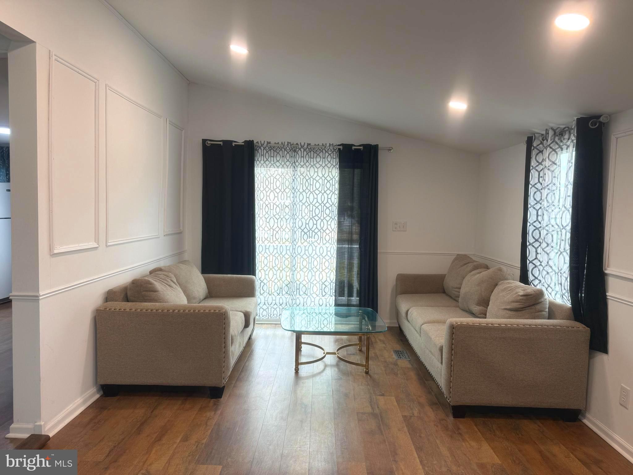 33987 Sunflower Road, Unit 3831 Lewes, DE 19958 - Photo 3 of 17 a living room with furniture and a large window
