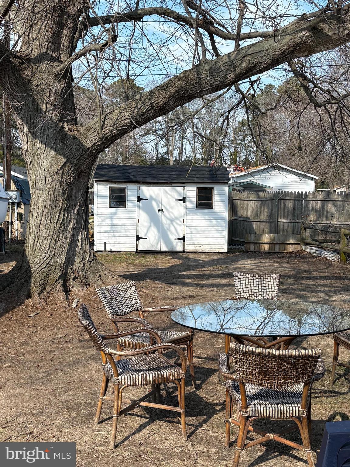 33987 Sunflower Road, Unit 3831 Lewes, DE 19958 - Photo 6 of 17 a view of a patio with table and chairs with wooden floor and fence