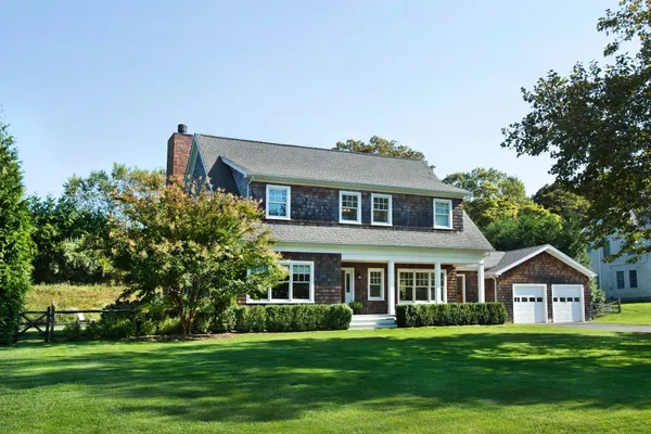 a front view of a house with a garden