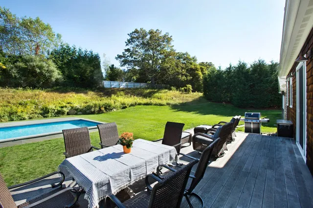an outdoor sitting area with furniture and garden