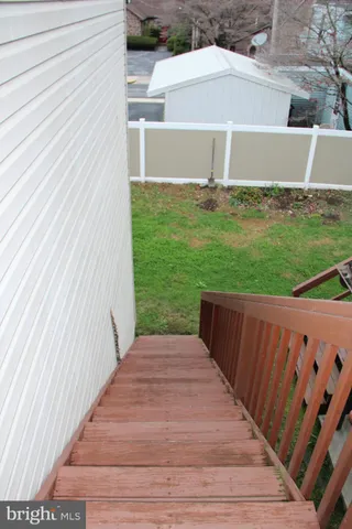 a view of a backyard with wooden fence