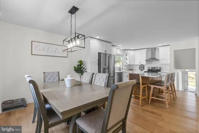 a view of a dining room with furniture wooden floor and chandelier