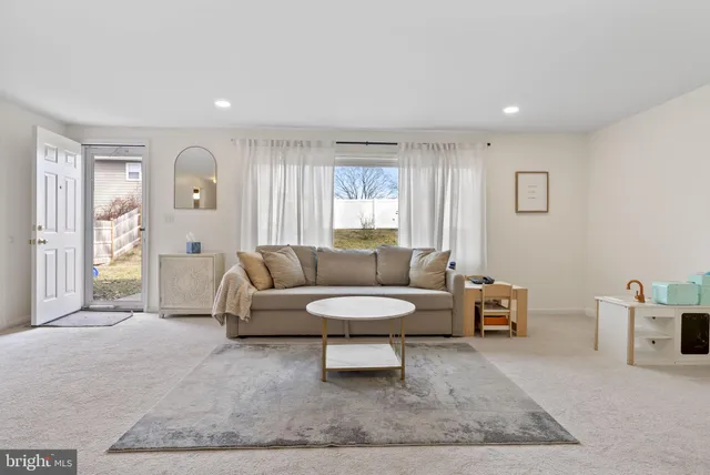 a living room with furniture and a rug